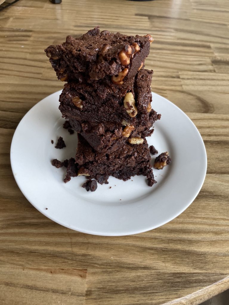 made with love chocolate brownies with walnuts on a white plate