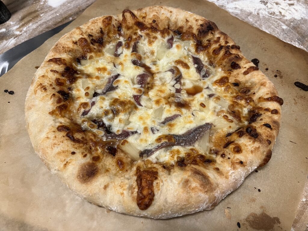 perfectly cooked pizza on parchment paper #perfectpizzadough #pizza #pizzacrust #neopolitanstylepizza