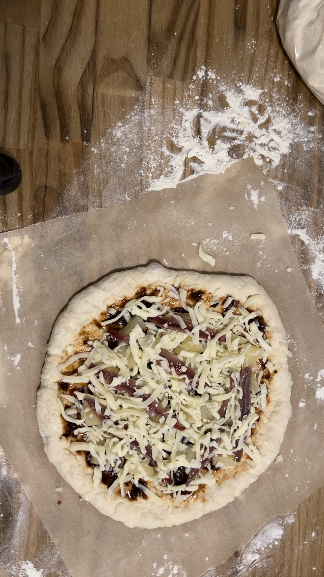 uncooked perfect pizza dough on parchment paper #perfectpizzadough #pizza #pizzacrust #neopolitanstylepizza #pizza dough recipe 