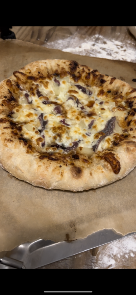 perfectly cooked pizza on parchment paper #perfectpizzadough #pizza #pizzacrust #neopolitanstylepizza